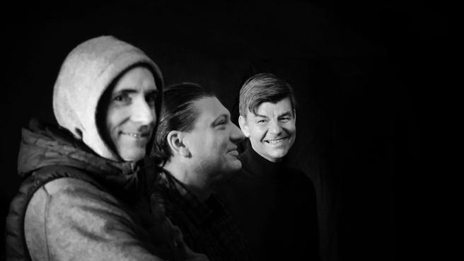 Drei Männer vor schwarzem Hintergrund, Schwarzweißfotographie